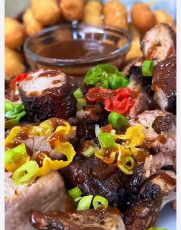 Jerk pork topped with scotch bonnet peppers and scallions